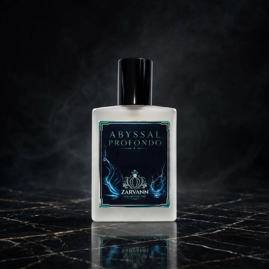 A square frosted glass bottle of Zarvann Abyssal Profondo fragrance, featuring a black cap and a dark navy label with blue flame-like graphics, set on a dark marble surface with a smoky background.